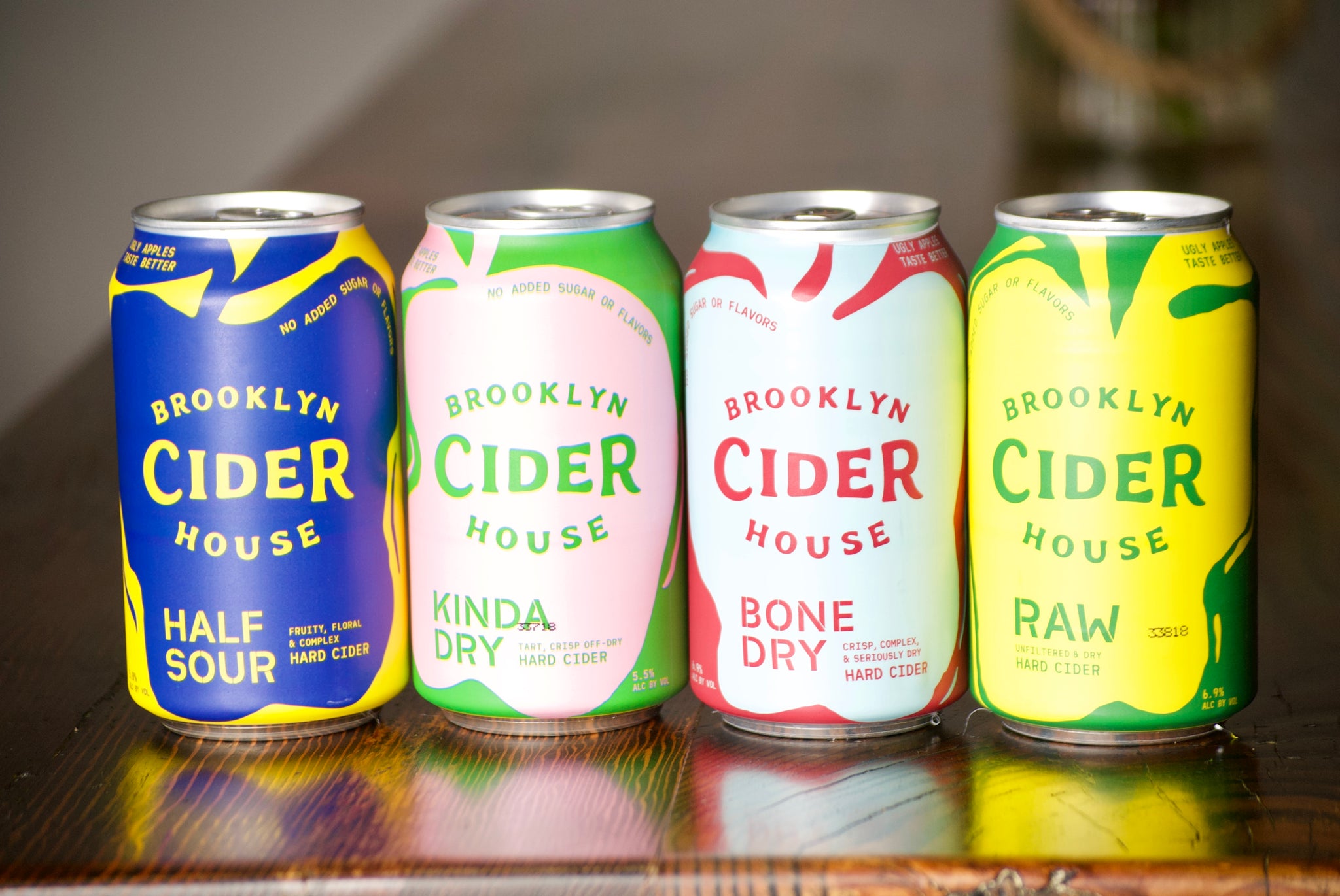 A flight of Brooklyn Cider House cans — the dry, native-yeast cider line distributed in NY, NJ, CT, MD, VA, DC, and FL