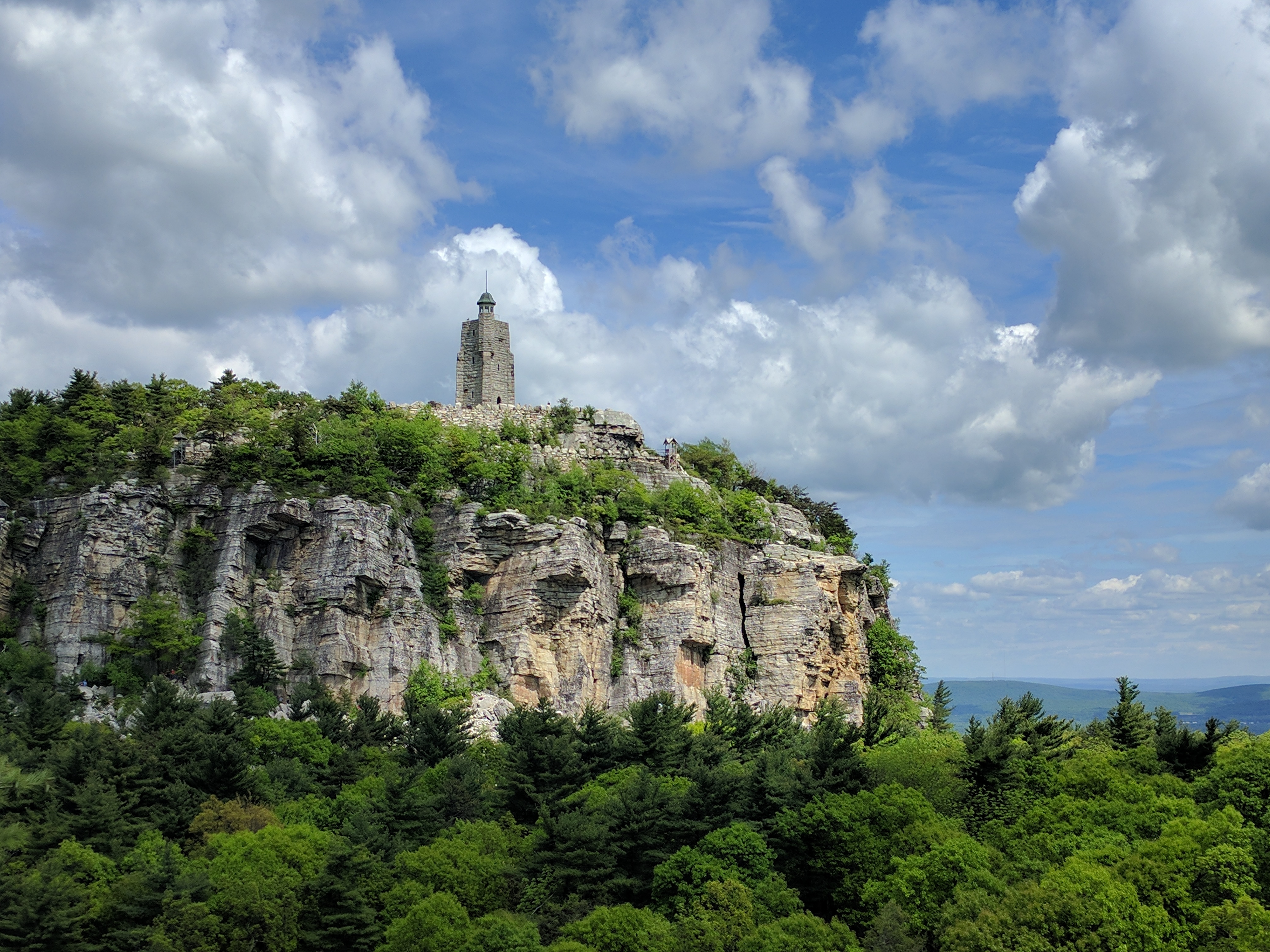 The Albert K. Smiley Memorial Tower on Sky Top above Lake Mohonk — the 1923 stone tower built by the family to honor the founder, viewed across the lake