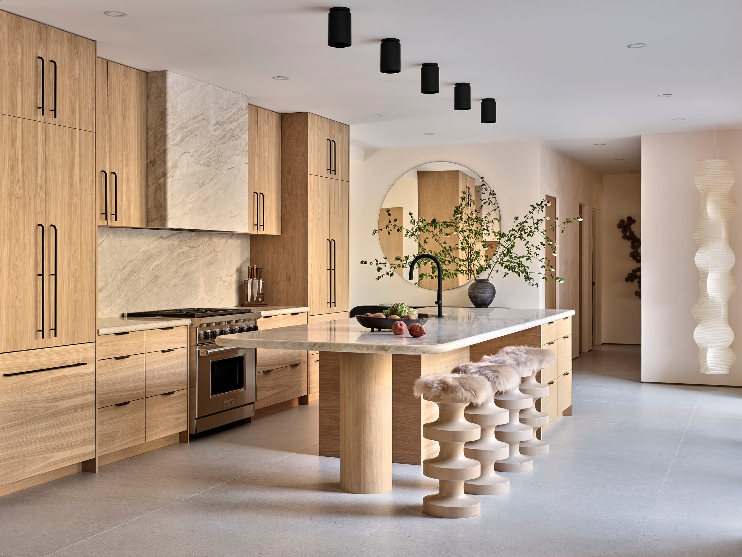 The kitchen: white oak millwork, Taj Mahal quartzite and a twelve-foot island.