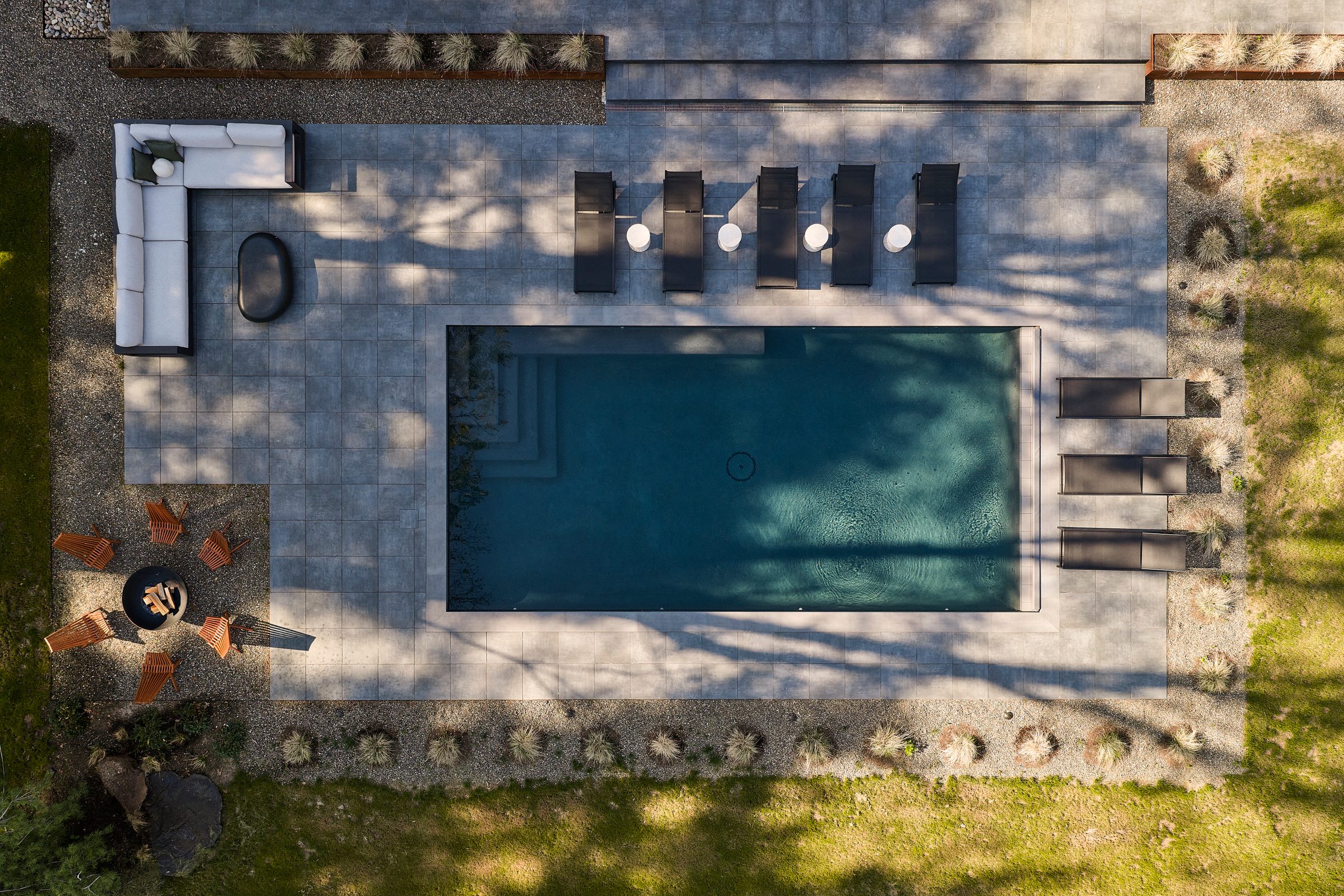 Overhead view of the pool, terrace, loungers and fire pit.