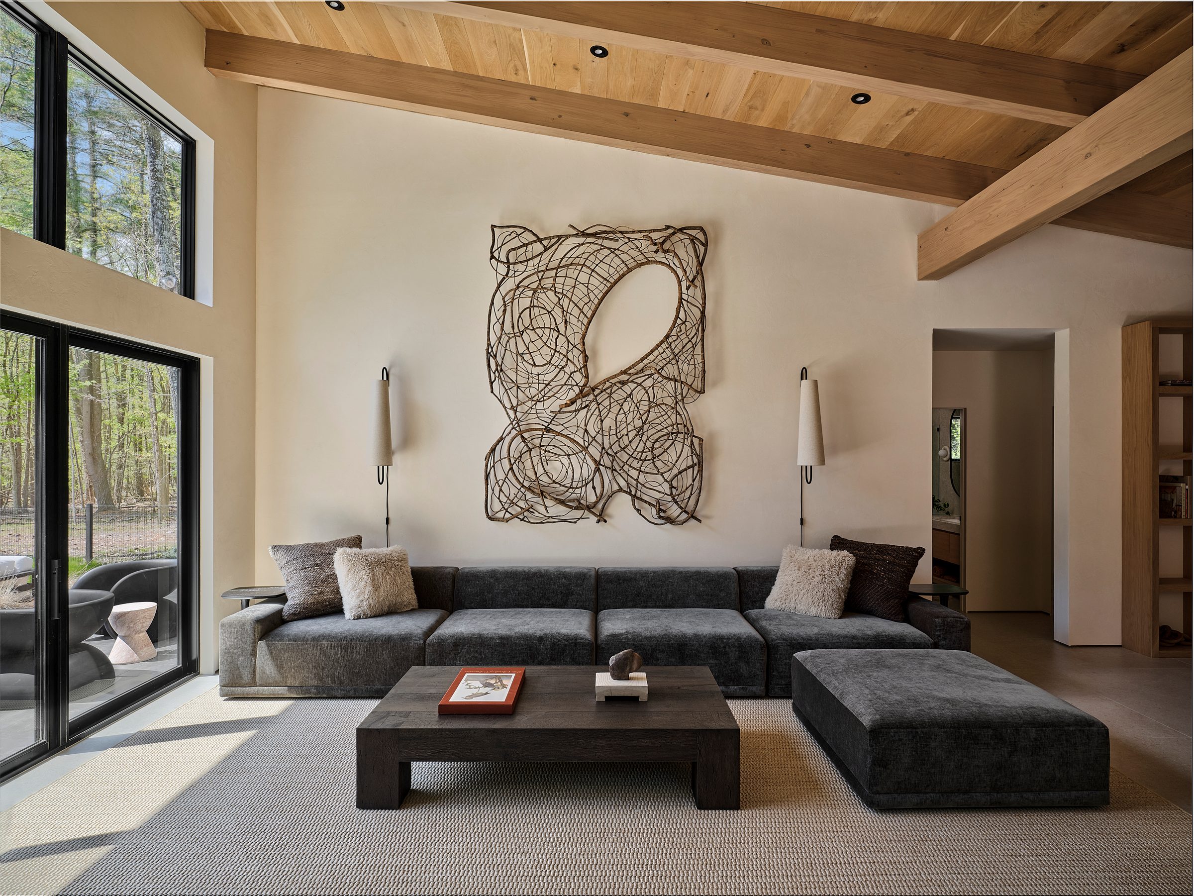 A living room under an exposed-beam wood ceiling, with sliders to the outside.