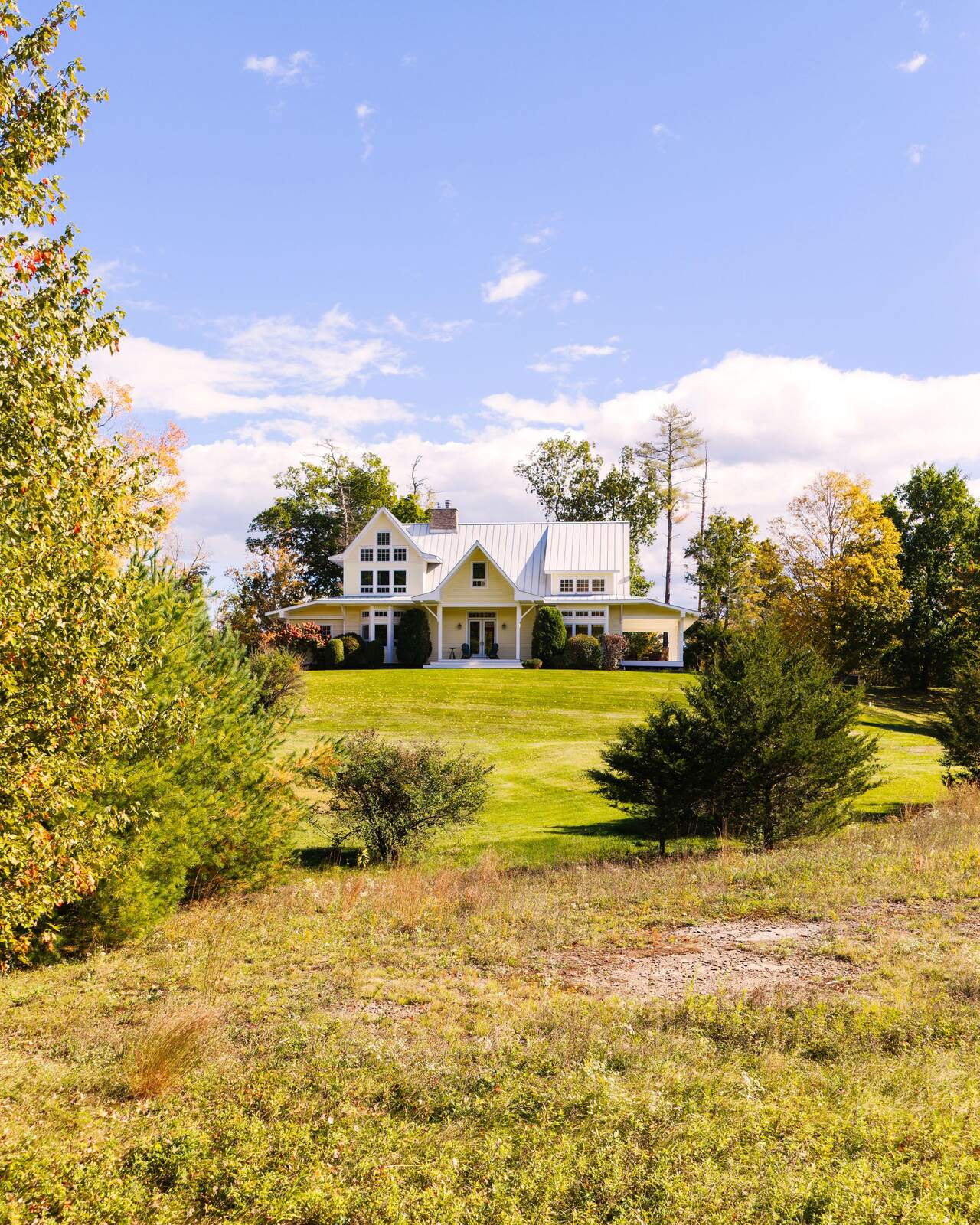 The house seen across the open field.