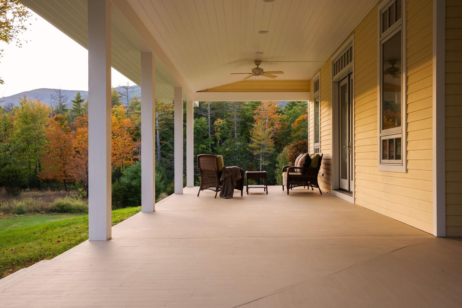 The covered porch looking out to the trees and the mountain.