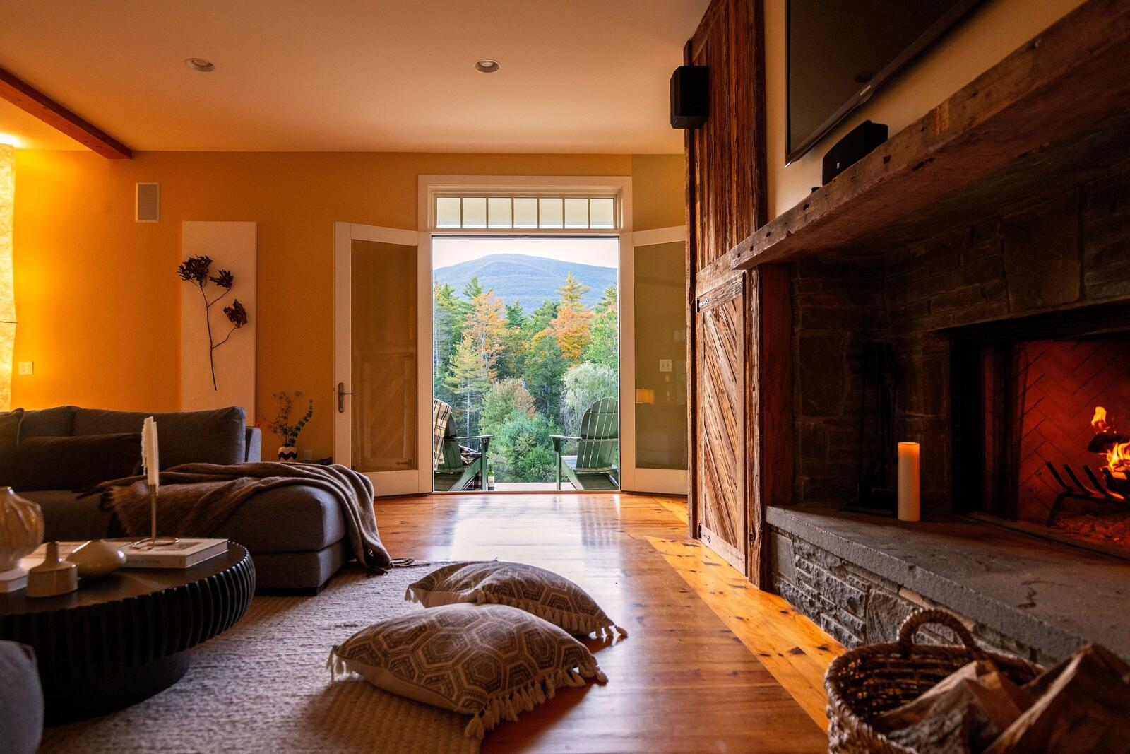The great room fireplace, and French doors open to the view.