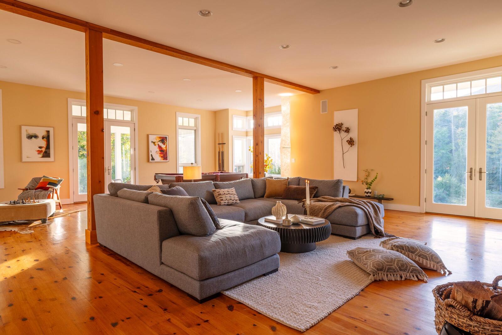 The great room, wide pine floors and windows all around.