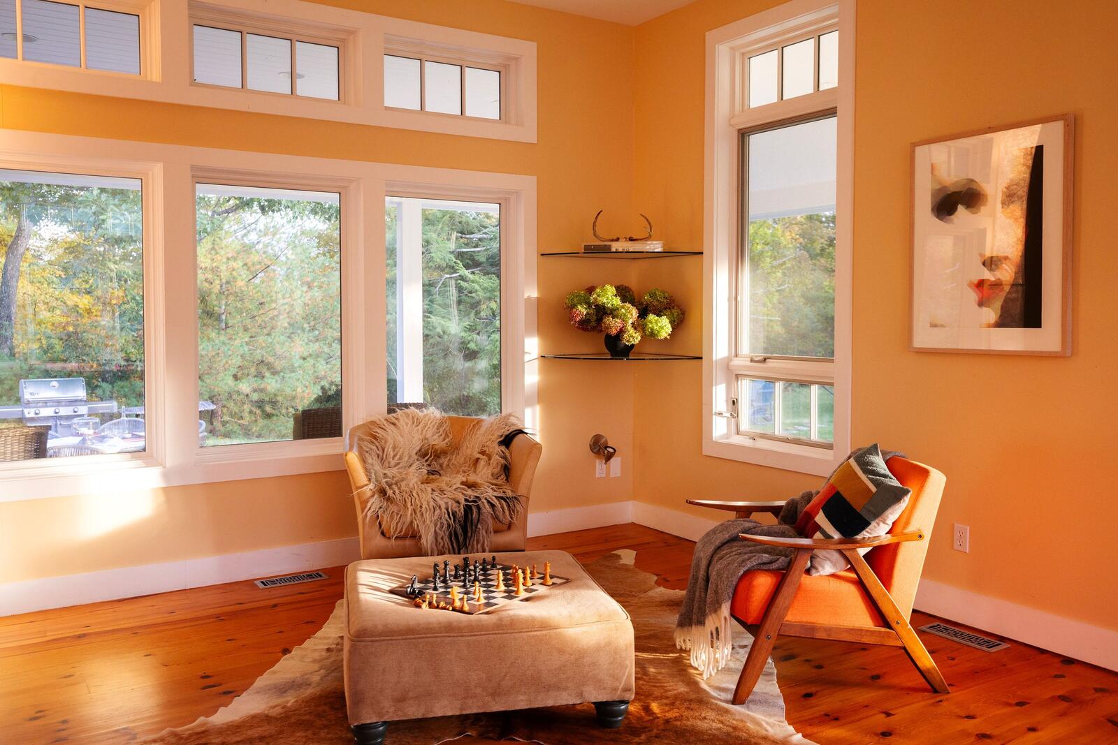 A sitting corner with a chessboard by the windows.