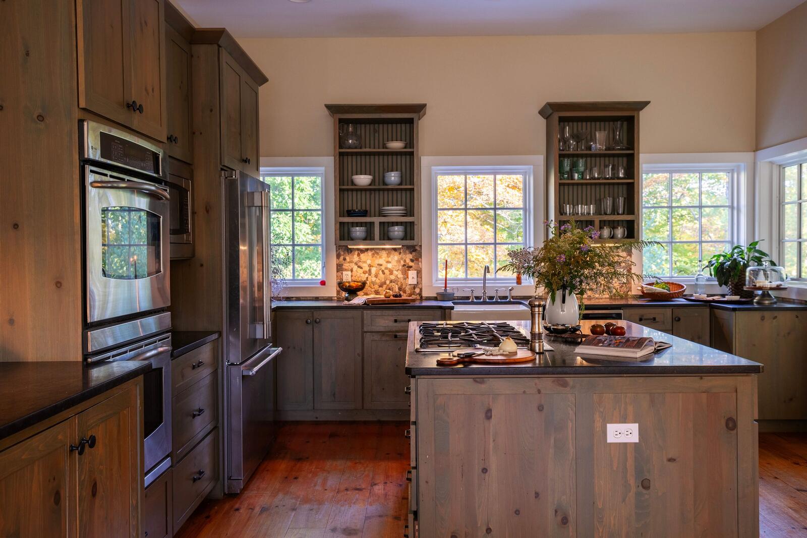 The island and range, open shelving beyond.