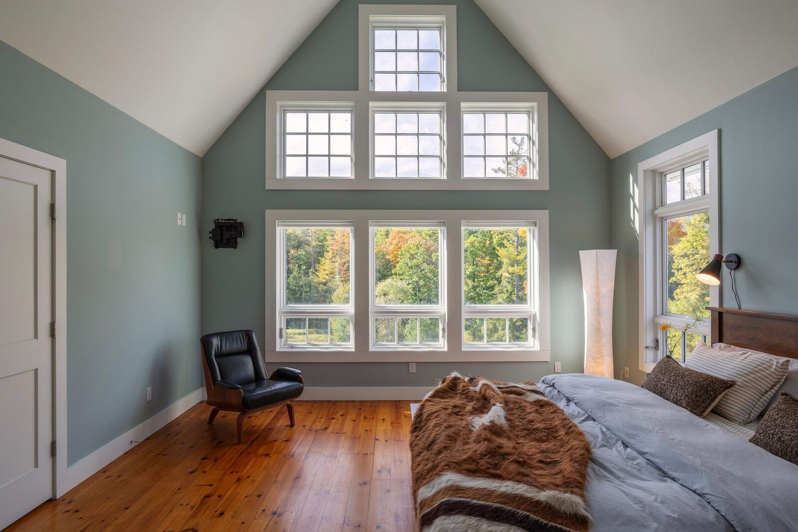 The primary suite under a vaulted ceiling.