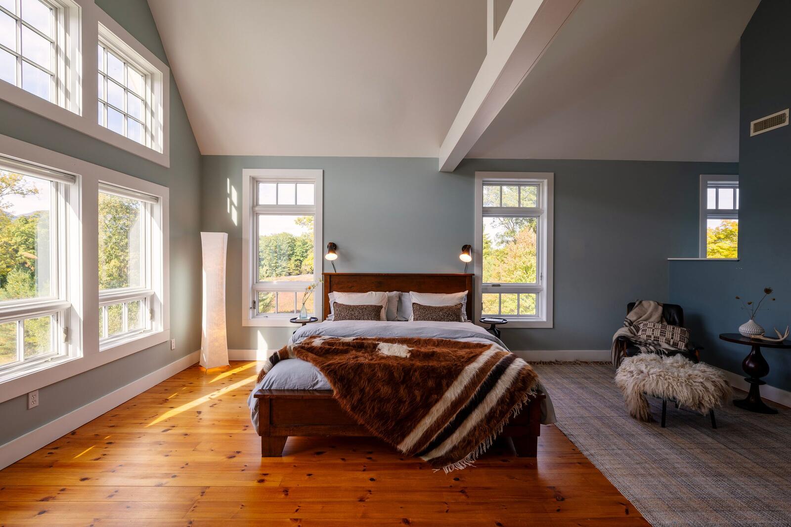 The primary bedroom, windows high and low.