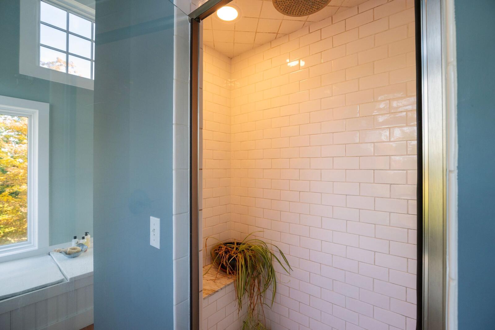 The walk-in shower in white tile.