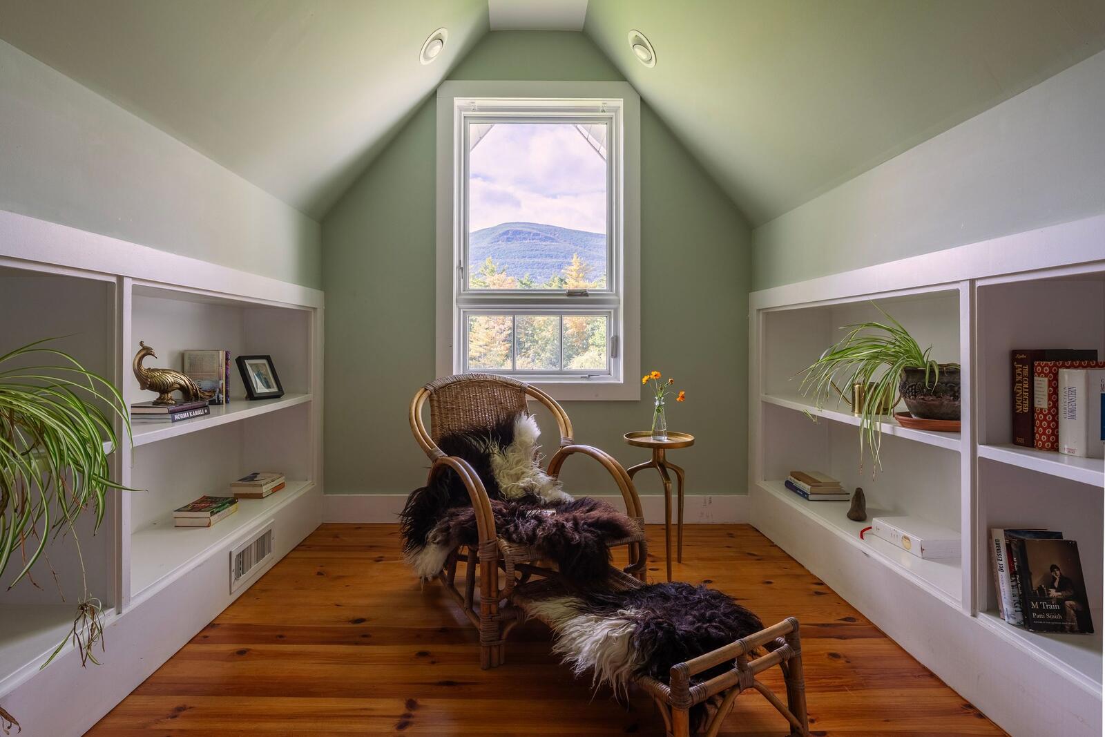 The reading room, built-in shelves and a window to the mountains.