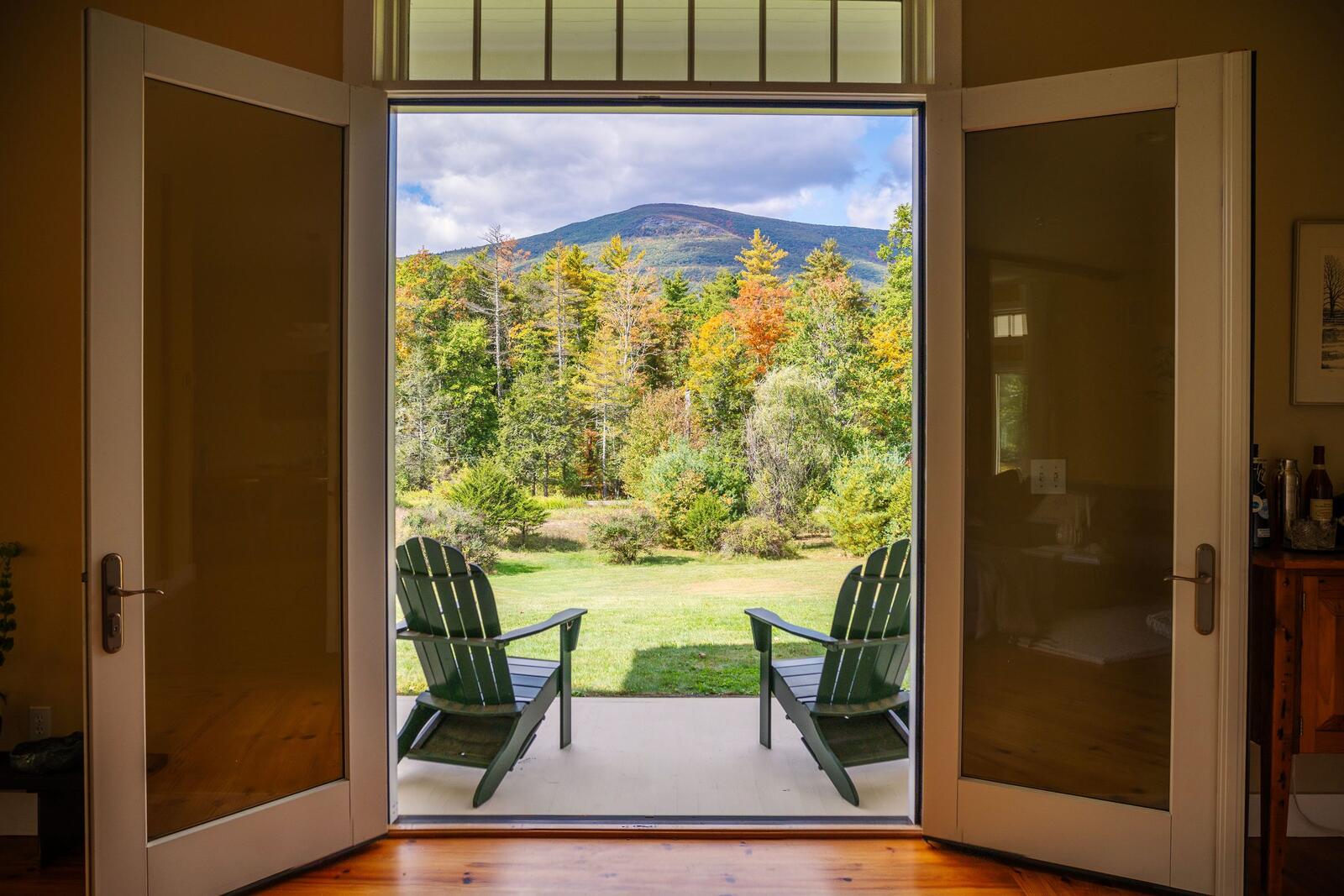 Doors open to the lawn and the mountain.