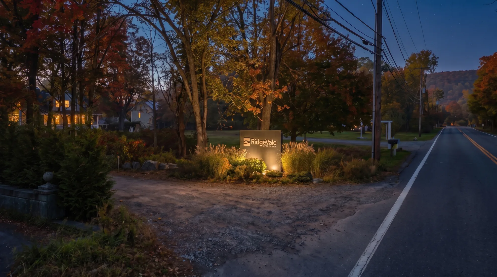 RidgeVale entrance signage — the monolith at night, lit