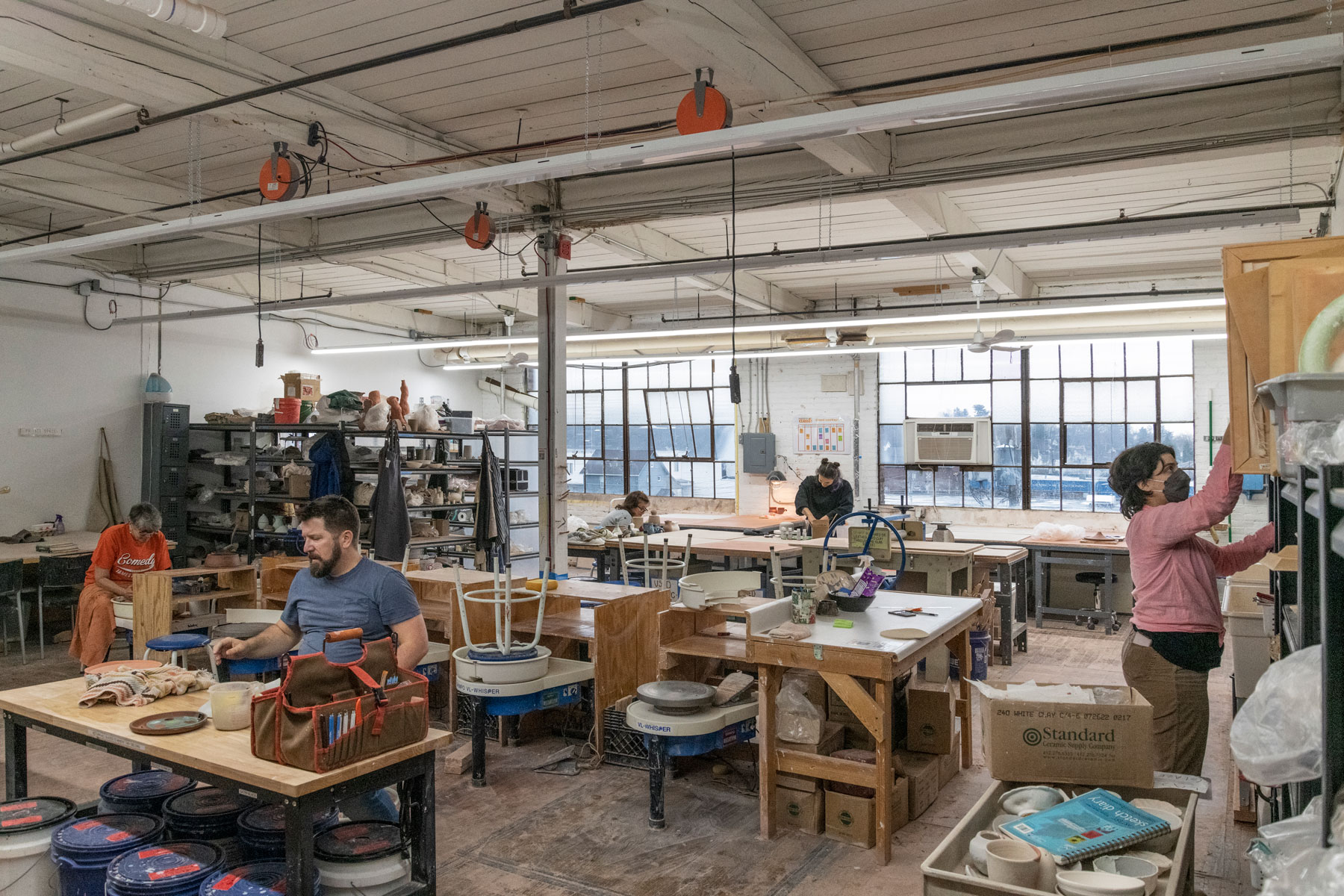 Inside The Shirt Factory — exposed brick, thirteen-foot ceilings, the original hardwood beams and natural north light from factory windows