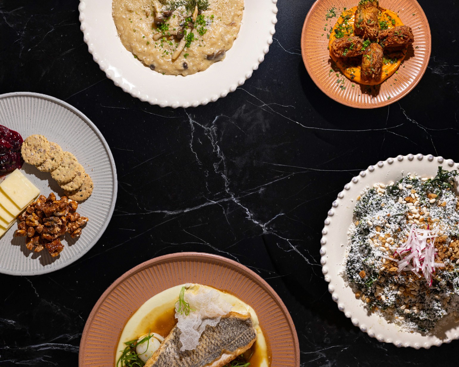 The dining room at The Wild Kitchen & Bar — bright, industrial-inspired, tall windows, the same space that runs counter service by day and full-service dinner by night